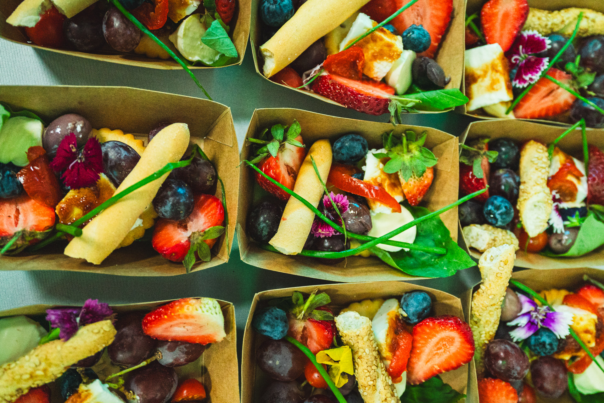 Close-up of fresh fruit and savoury catering boxes